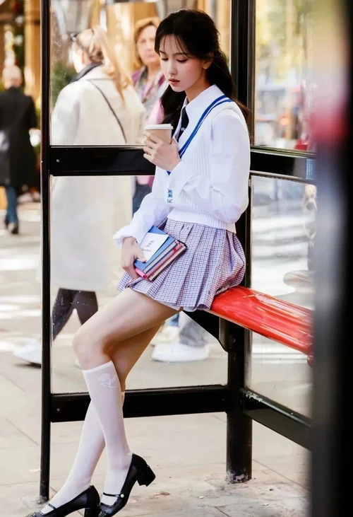 Classic Preppy Style with White Blouse, Plaid Skirt, and Blue Trim Vest
