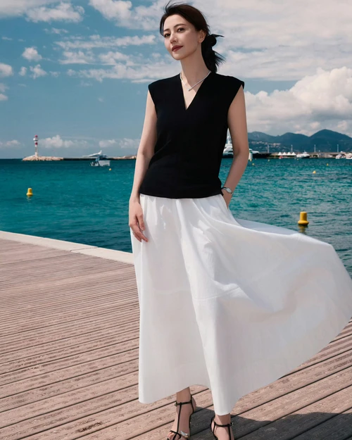 Elegant Monochrome Seaside Style with Black Sleeveless Top and White Maxi Skirt