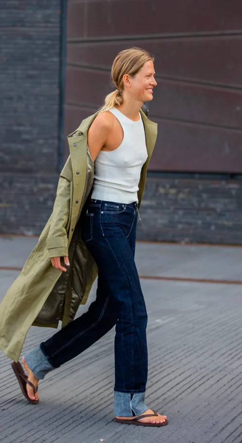 Casual Chic Street Style: Olive Trench Coat with Dark Jeans and Ribbed Tank