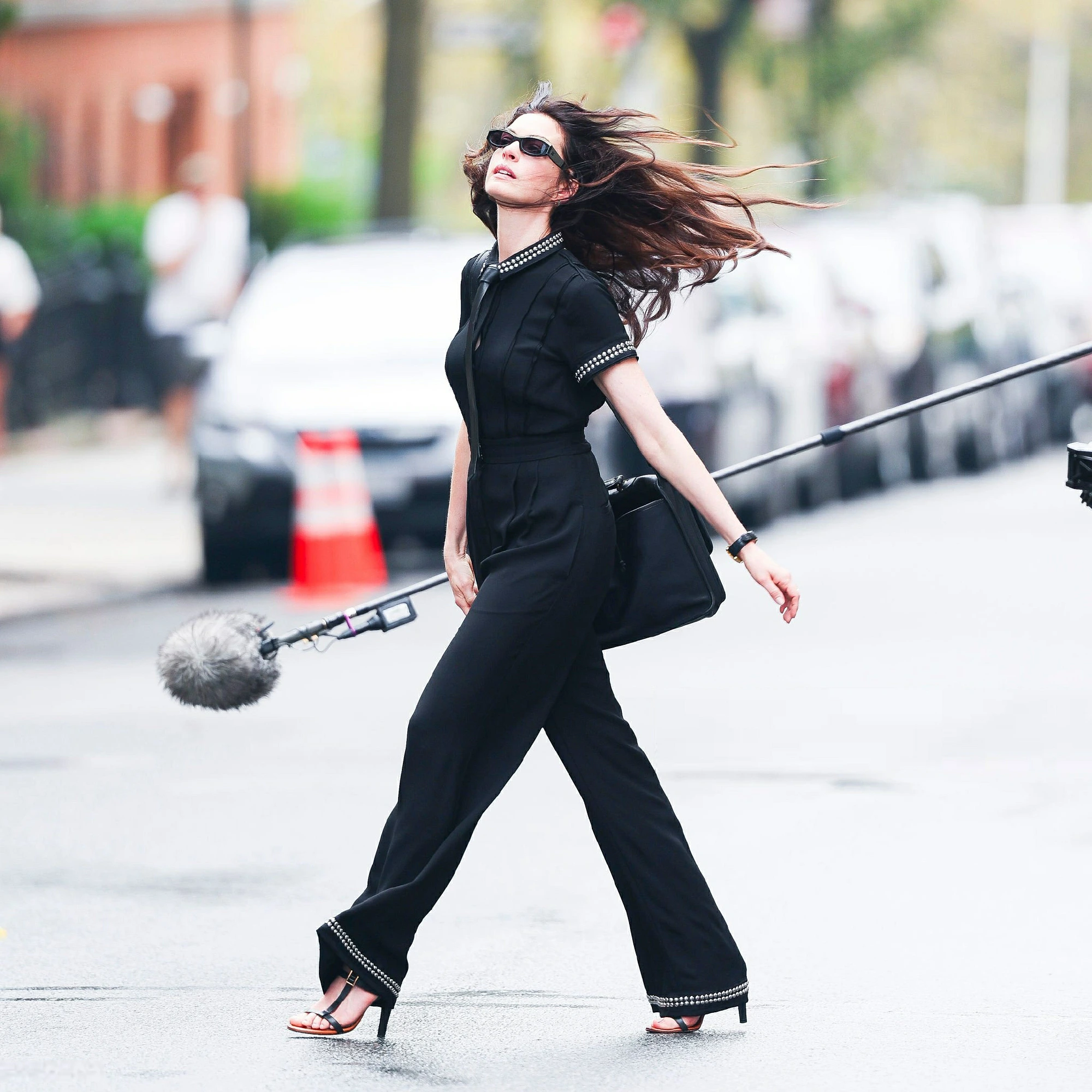Elegant Black Jumpsuit with Strappy Heels and Subtle Embellishments for a Chic Street Style