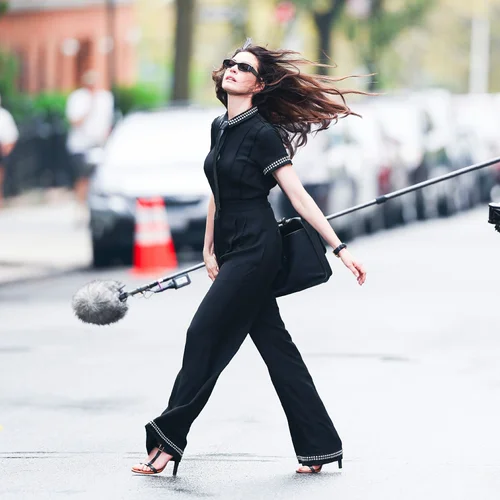 Elegant Black Jumpsuit with Strappy Heels and Subtle Embellishments for a Chic Street Style