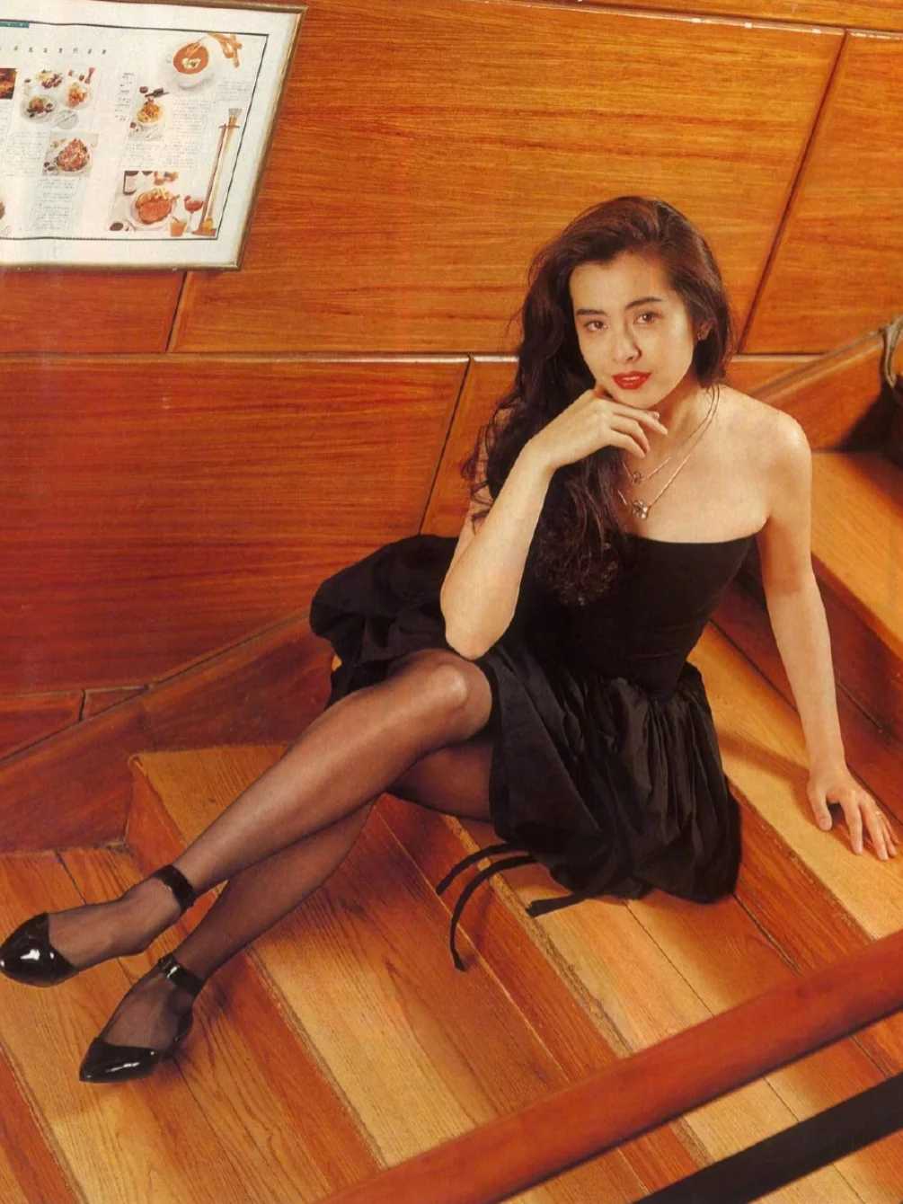 Timeless Black Strapless Dress Paired with Sheer Stockings and Shiny Heels