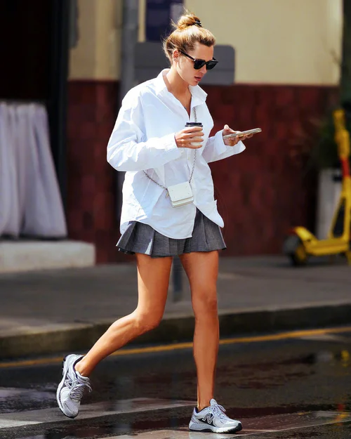 Casual Chic: White Shirt and Grey Mini Skirt with Sporty Sneakers