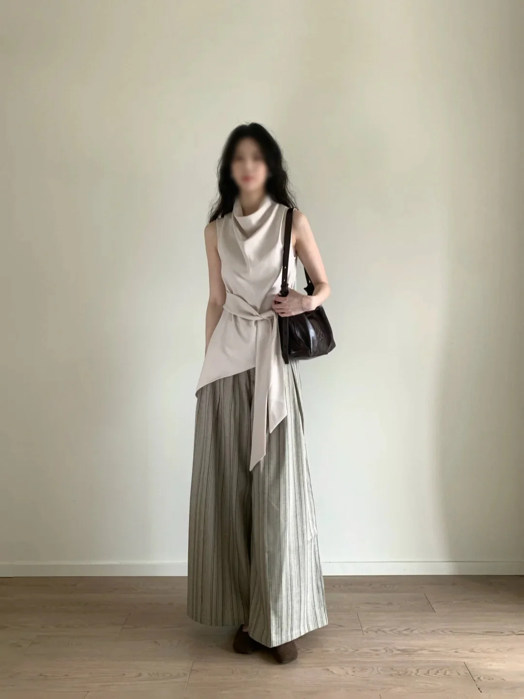 Elegantly Neutral: Ivory Wrap Top with Striped Palazzo Pants and Brown Accessories