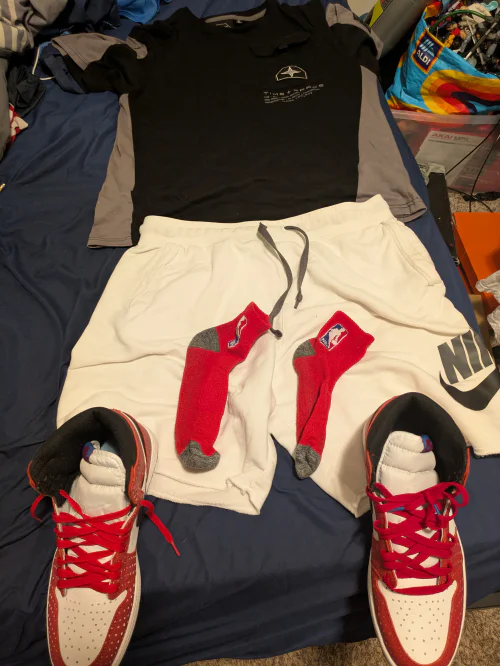 Sporty Chic: Black and Gray Athletic Shirt with White Nike Shorts and Red Accented Sneakers