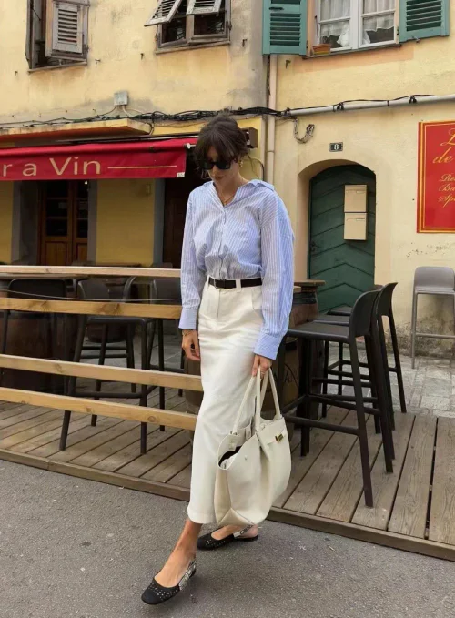 Effortlessly Chic: Light Blue Striped Shirt and White Skirt Ensemble with Black Accents