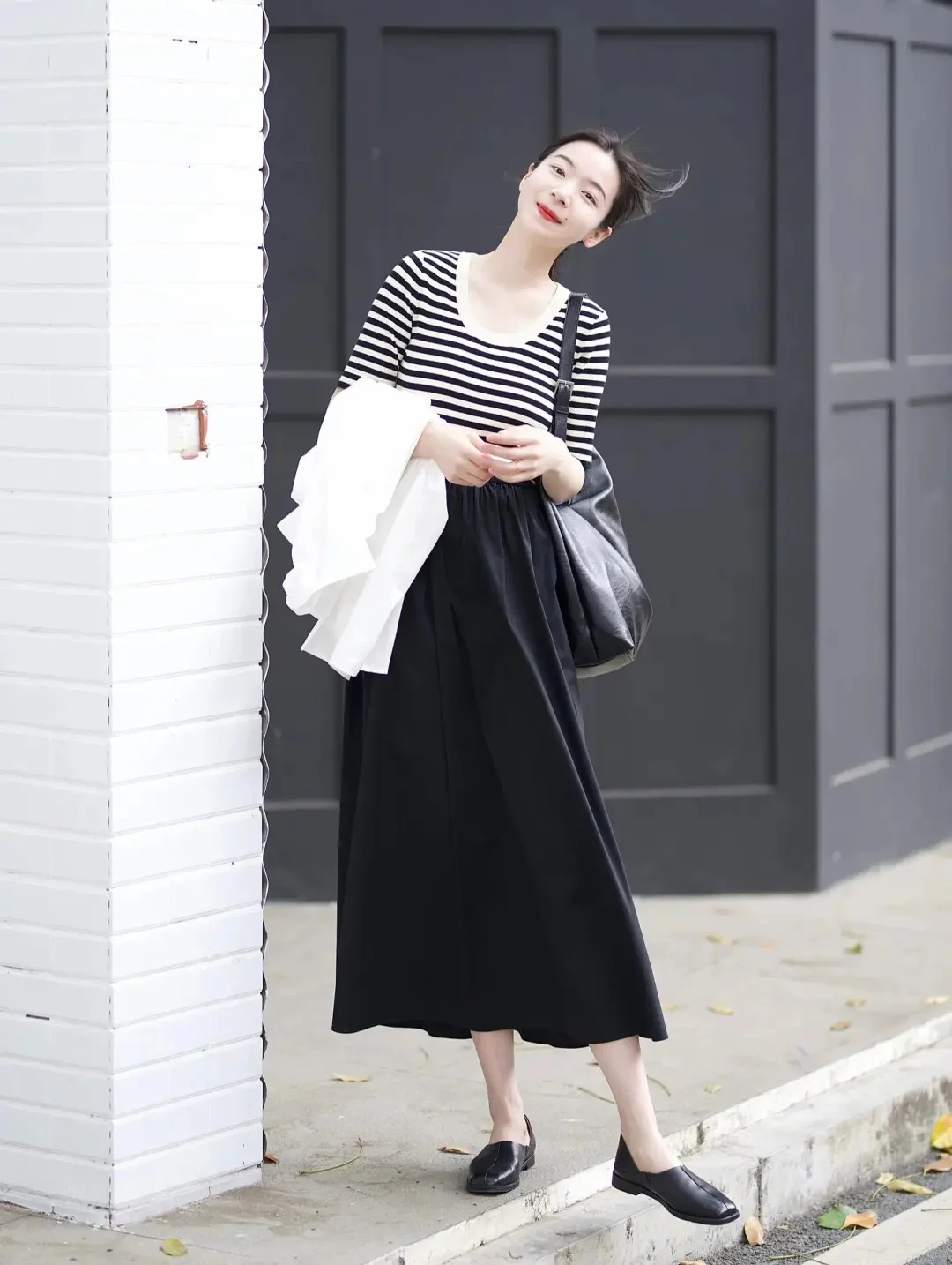 Chic Monochrome Outfit with Striped Top and Flowing Black Skirt