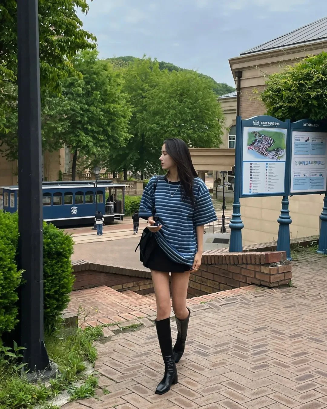 Effortlessly Chic with a Striped Oversized T-shirt, Mini Skirt, and Knee-High Boots