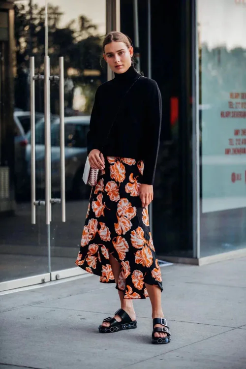 Chic Black Turtleneck and Bold Floral Skirt for a Stylish Street Look