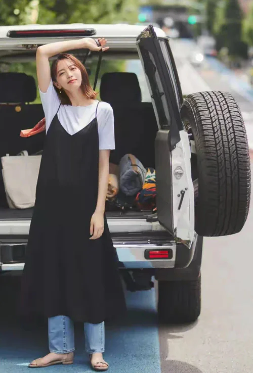 Stylish Layering with Black Slip Dress Over White T-Shirt and Jeans