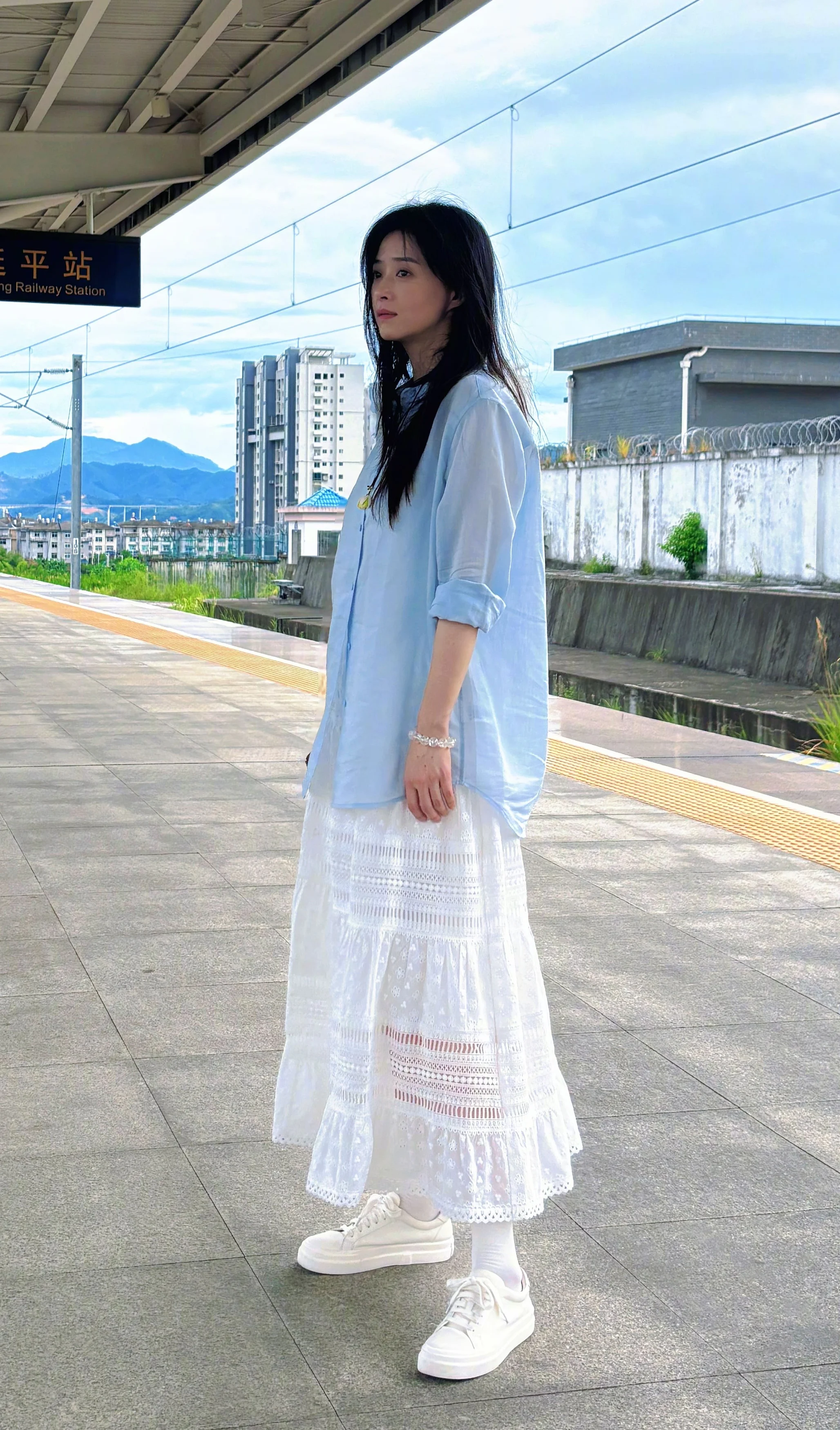 Casual Elegance with Light Blue Shirt and White Lace Maxi Skirt