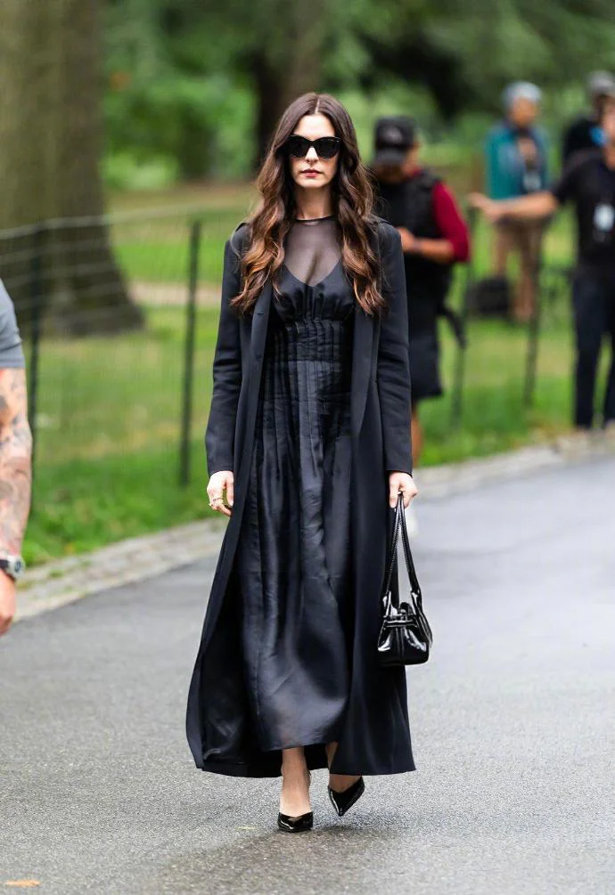 Elegant All-Black Ensemble with Long Coat and Sheer Details