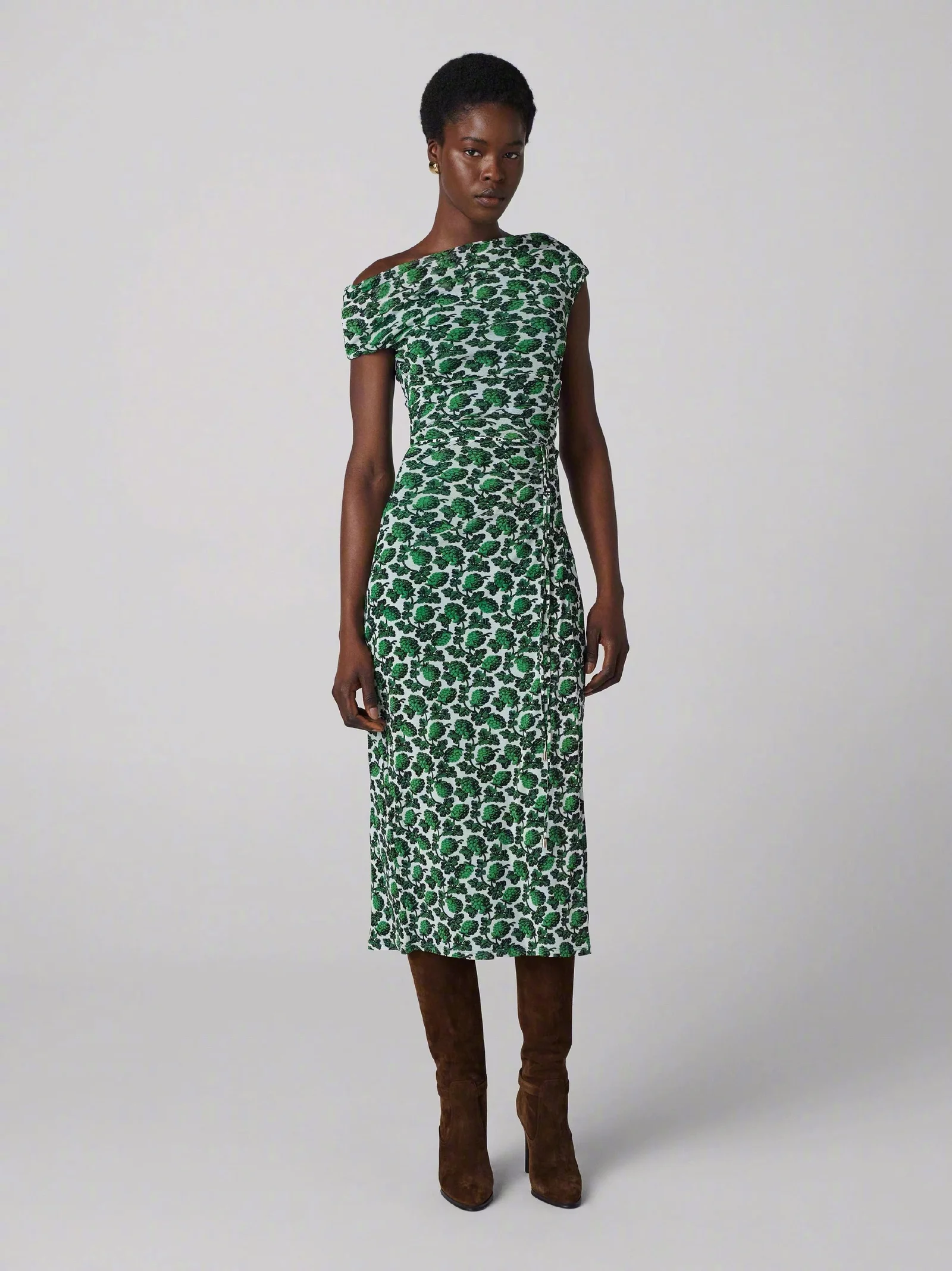Chic Green Patterned Dress with Asymmetrical Neckline and Brown Boots