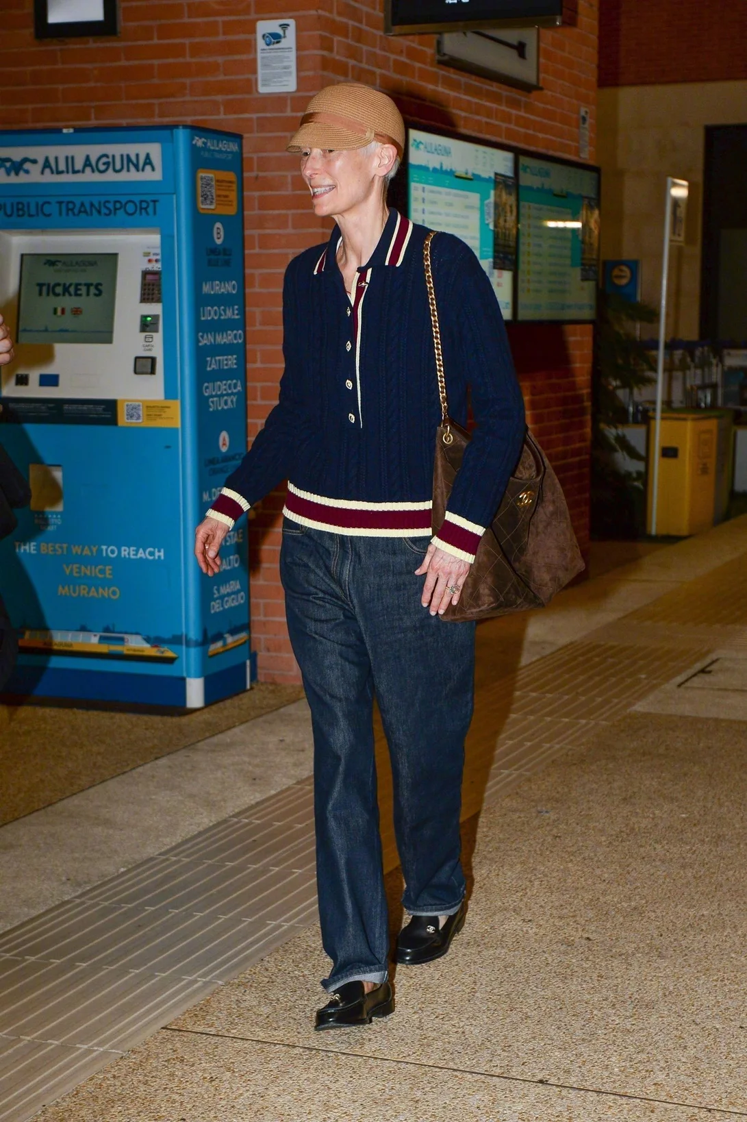 Casual Meets Classic: Navy Sweater, Denim Jeans, and Cap Ensemble
