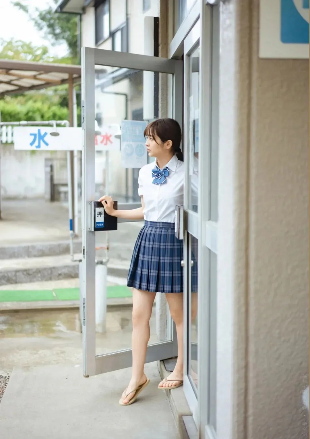 Classic School Uniform with White Shirt and Plaid Skirt Featuring Blue Bow