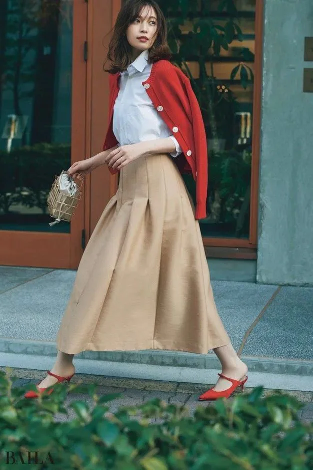 Classic Elegance with Red Accents: Styling a White Blouse, Beige Skirt, and Cardigan