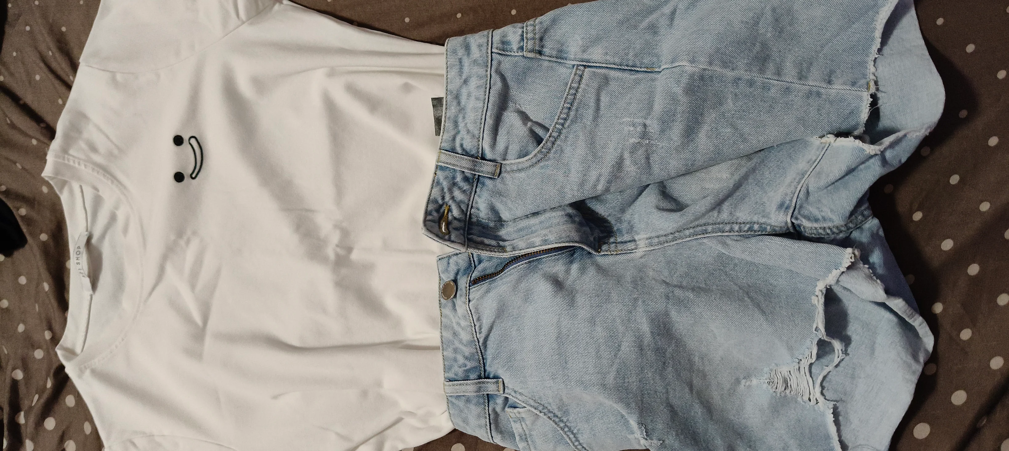 Casual Summer Style: White Tee with Smiley Face and Light Denim Shorts