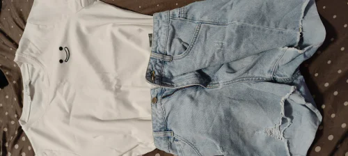 Casual Summer Style: White Tee with Smiley Face and Light Denim Shorts