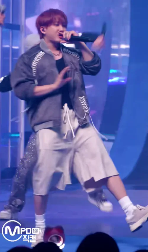 Casual Streetwear Vibes: Grey Jacket with Striking Detail and Cream Shorts