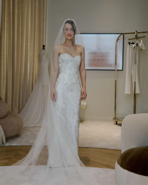 Kate Harrison in Wedding Dress. Timeless White Bridal Gown with Lace Detailing and Elegant Veil