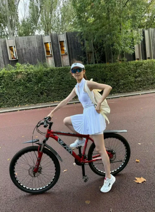 Sporty Chic in White Dress and Sneakers, Perfect for Cycling Adventures