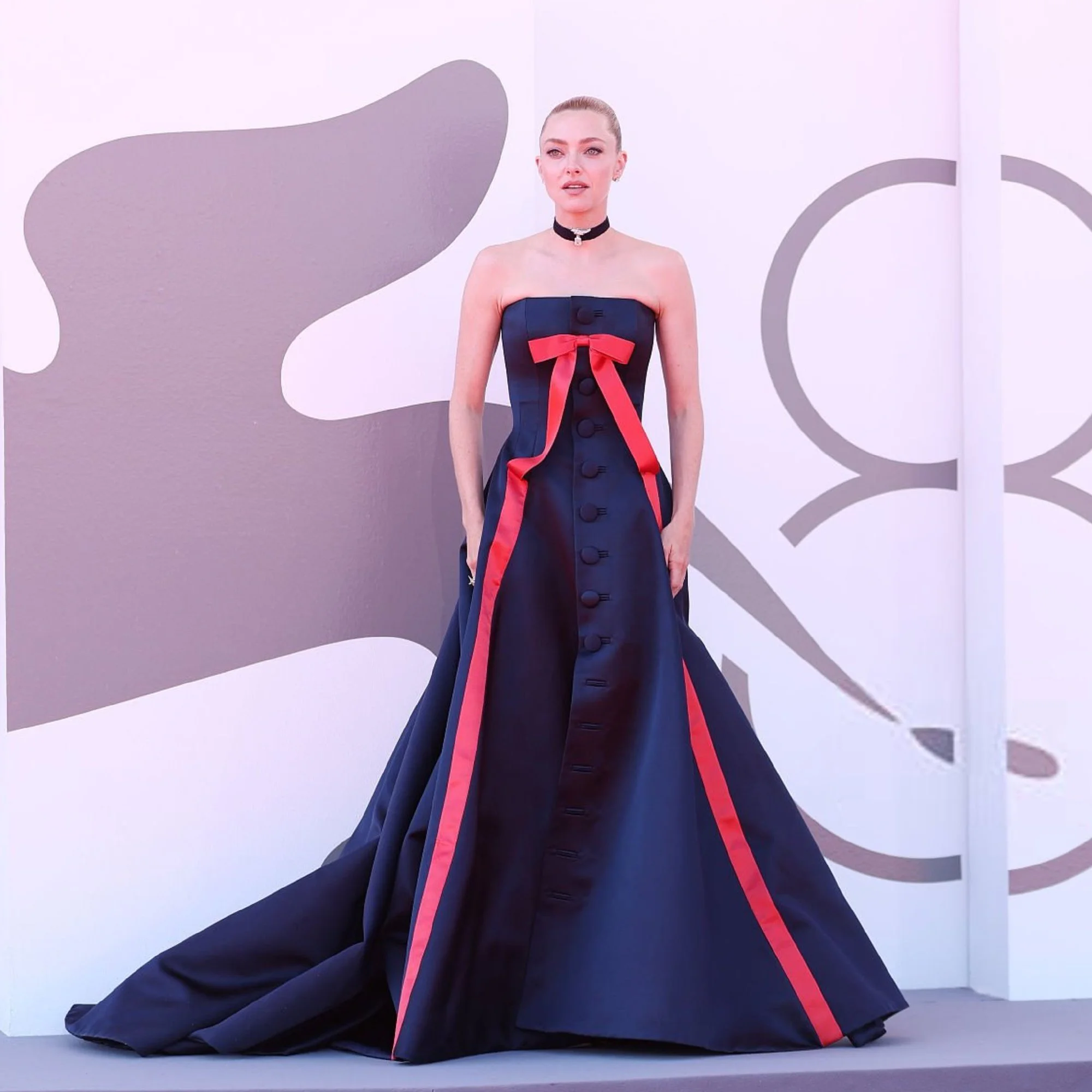 Amanda Seyfried in Venice. Elegant Strapless Navy Gown with Red Accents and Choker