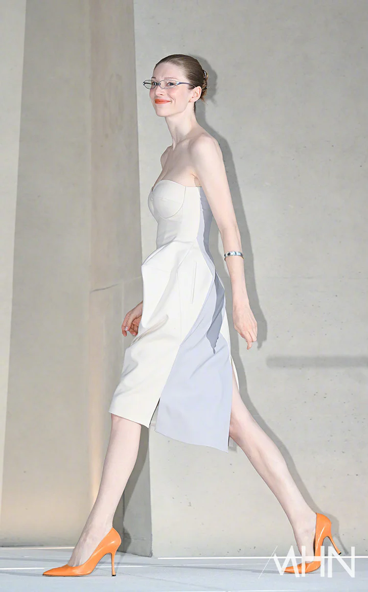 Elegant Asymmetrical Strapless Dress with Bold Orange Pumps
