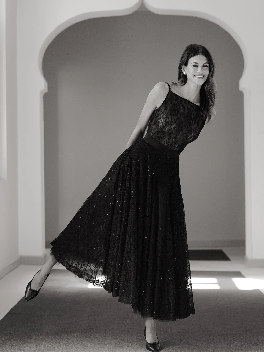 Kaia Gerbe in Venice Film Festival. Timeless Elegance: Black Lace Dress with Flowy Skirt and Heels