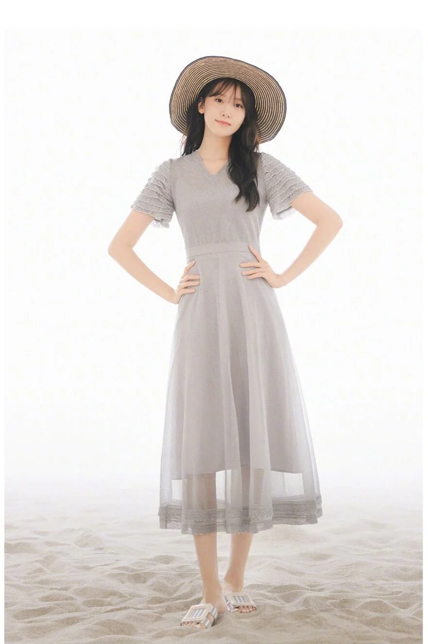 Elegant Gray Midi Dress with Straw Hat for a Chic Summer Look