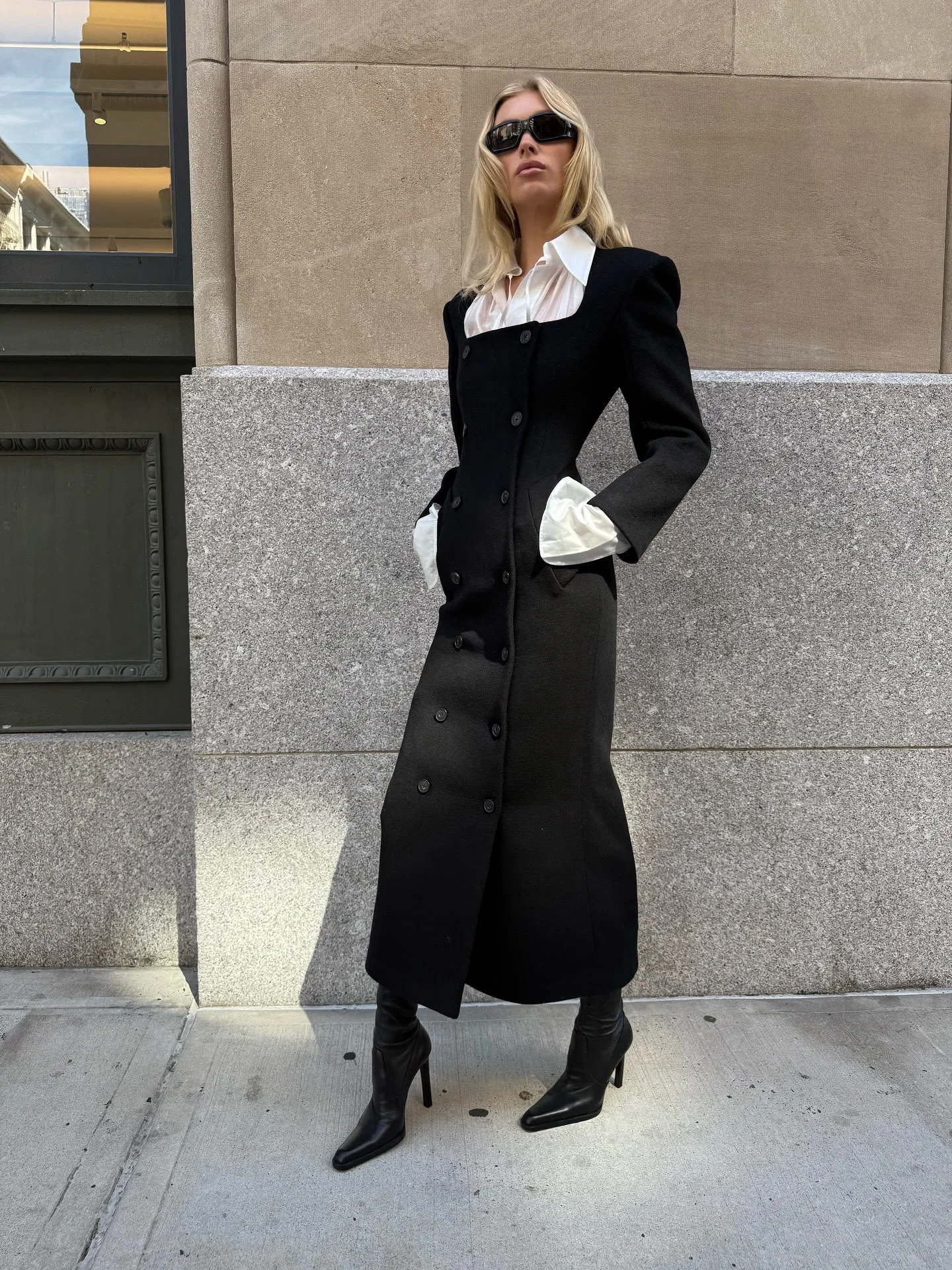 Elegant Black Long Coat with White Accents and Sleek Accessories