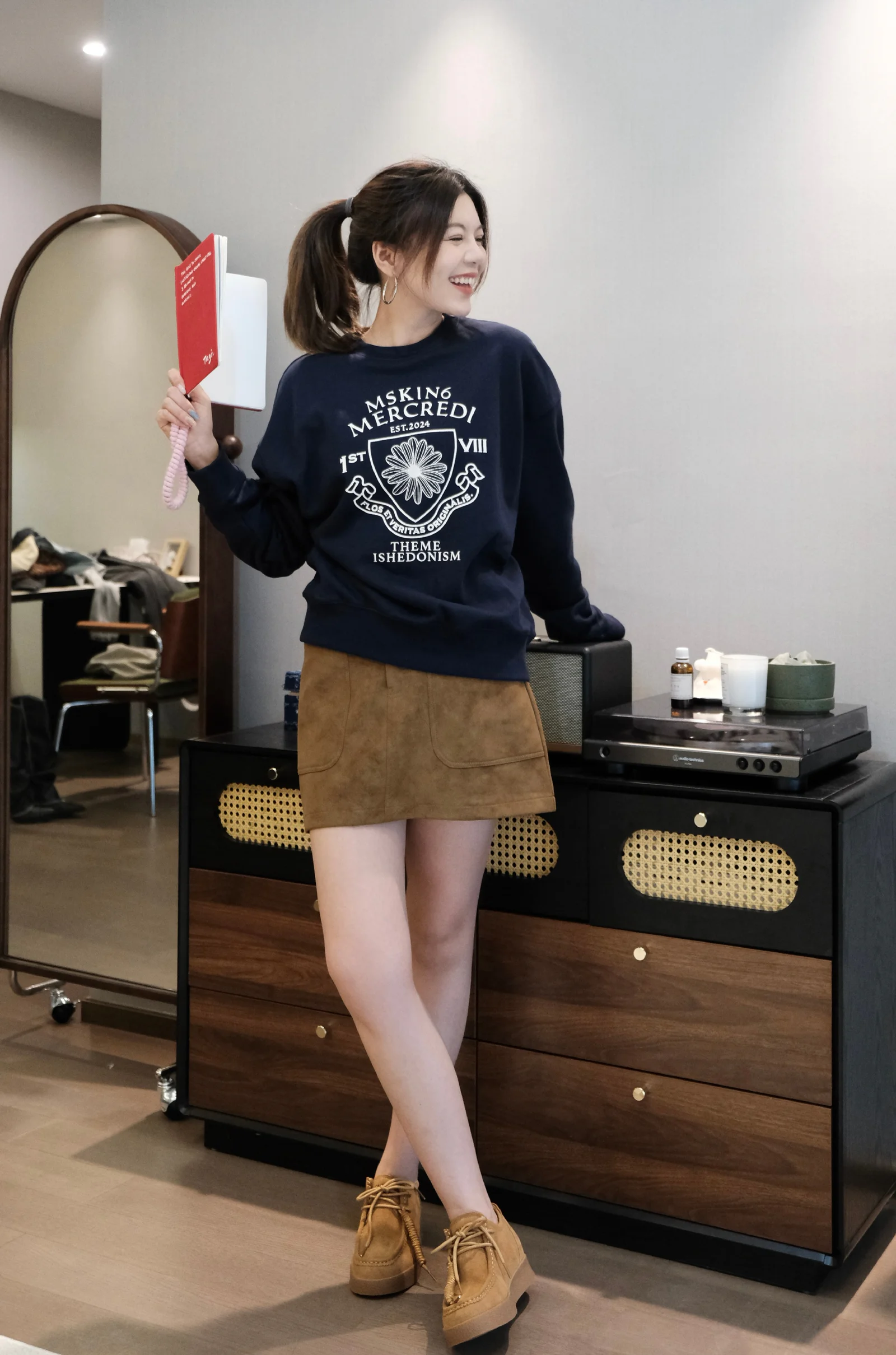Navy Graphic Sweater and Suede Skirt: A Casual and Chic Ensemble