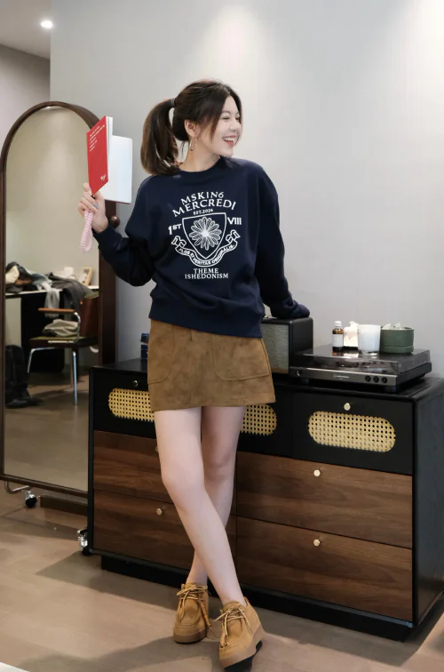 Navy Graphic Sweater and Suede Skirt: A Casual and Chic Ensemble