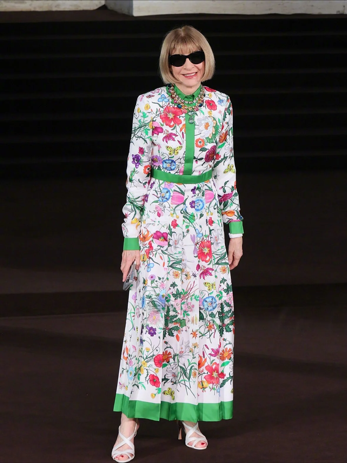 Vibrant Floral Dress with Green Accents and Elegant Accessories