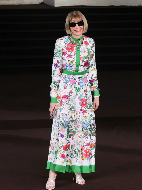 Vibrant Floral Dress with Green Accents and Elegant Accessories