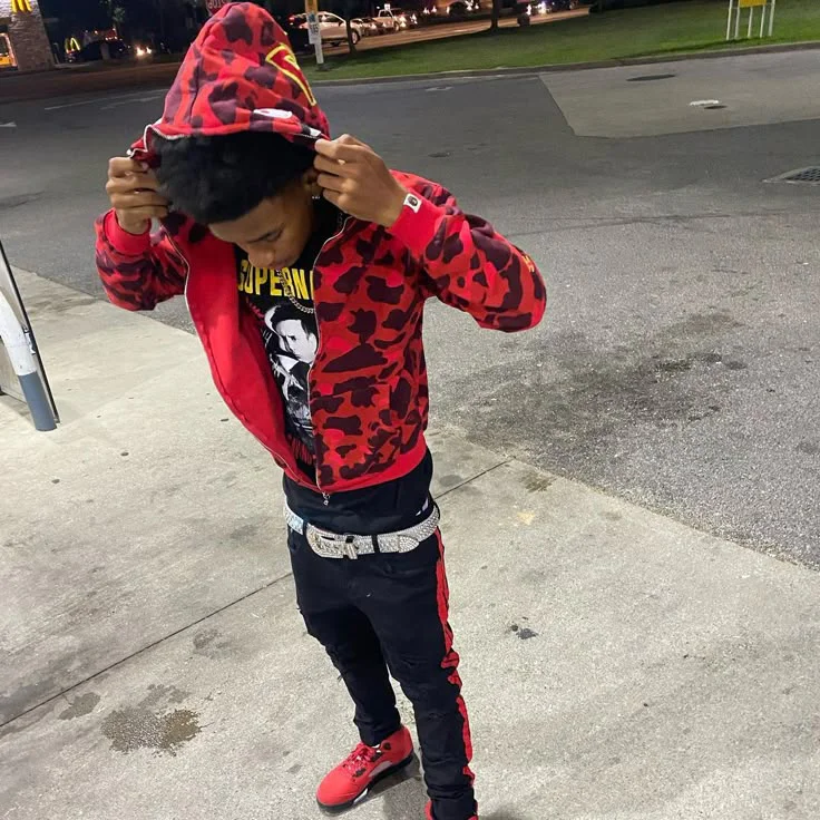 Bold Red and Black Streetwear Outfit with Camouflage Jacket and Graphic Tee