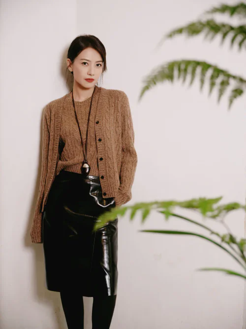 Cozy Brown Knit Ensemble with Black Patent Skirt and Long Necklace