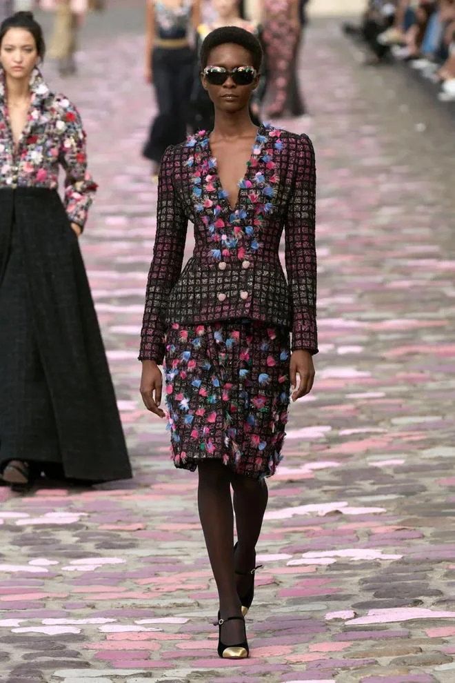 Elegant Floral Jacket and Skirt Set with Bold Colors and Modern Accessories