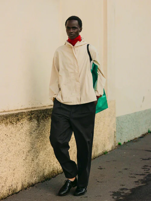 Contemporary Style with a Pop of Red and Green; Off-White Windbreaker, Red Turtleneck, and Black Trousers