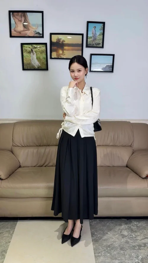 Elegant Monochrome Ensemble: White Blouse with Ribbon Details and Long Black Skirt