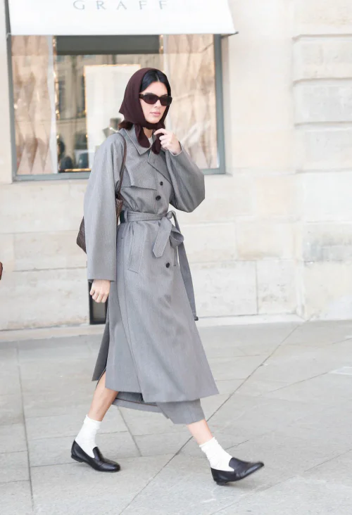 Kendall Jenner OOTD. Timeless Gray Trench Coat with Retro Accessories and Black Loafers