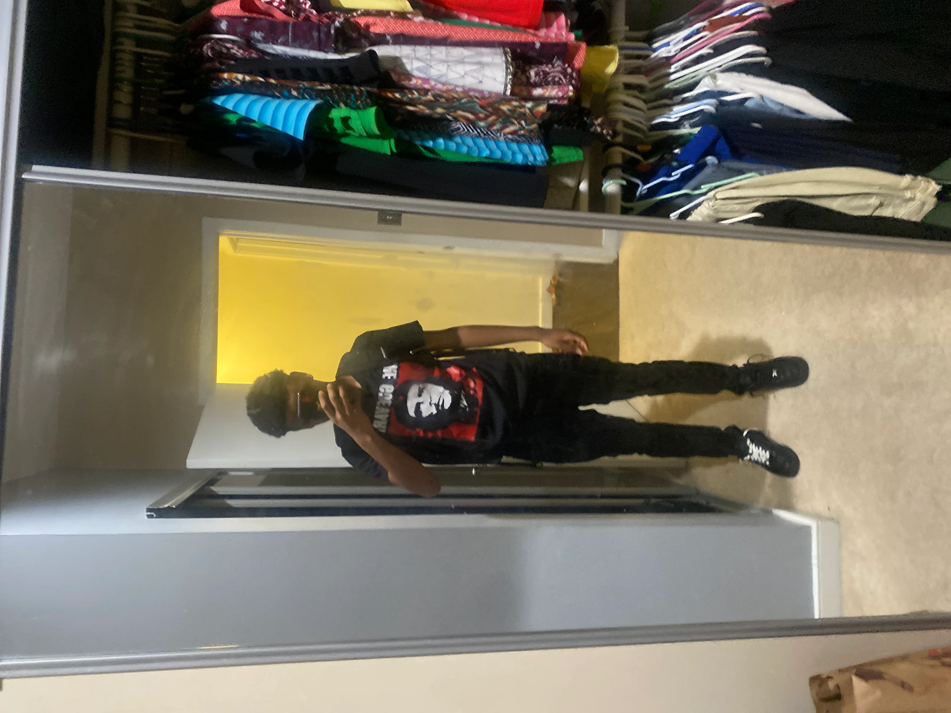 Casual Streetwear Ensemble with Bold Graphic Tee and Black Sneakers