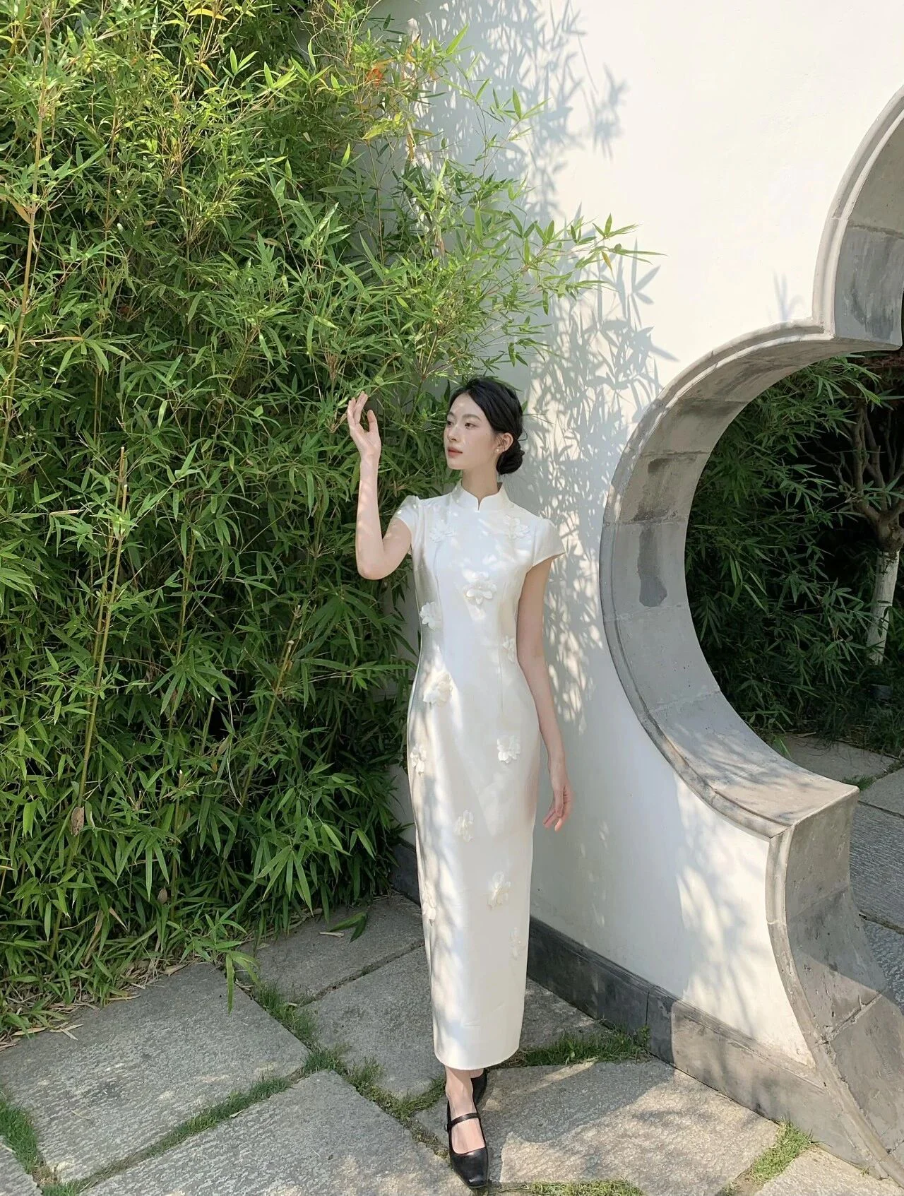 Elegant Ivory Cheongsam with Subtle Embellishments and Classic Black Heels