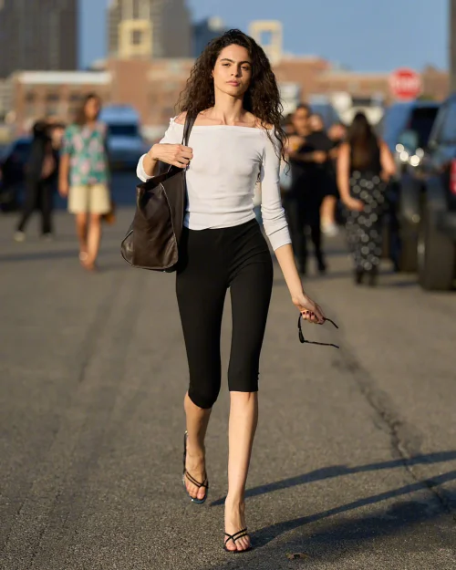 Effortless White Off-the-Shoulder Top with Black Leggings and Minimal Accessories