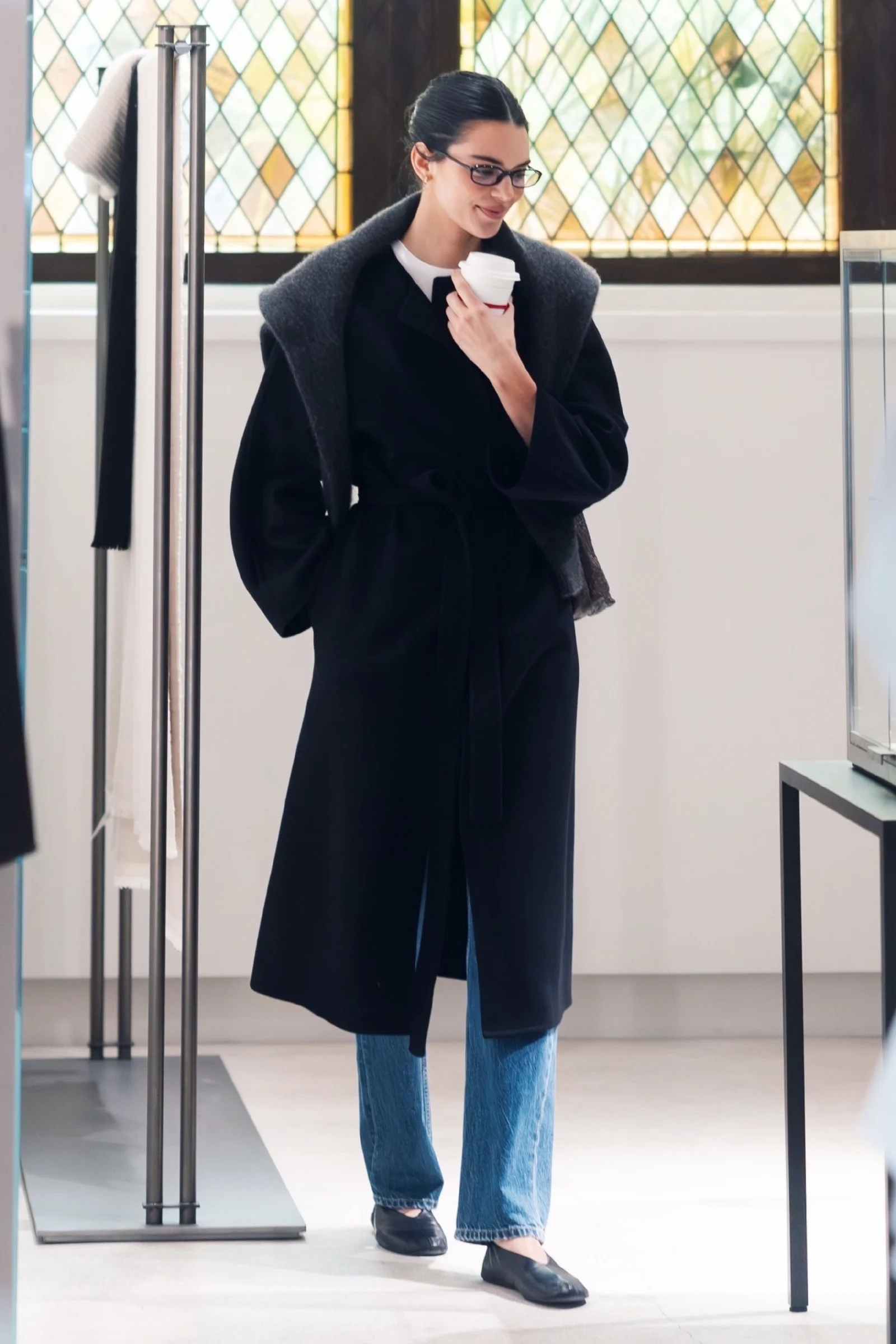 Kendall Jenner at Paris. Elegant Black Coat with Light Blue Jeans for a Chic Casual Look