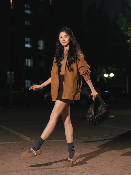 Casual Chic: Oversized Brown Jacket with Black Shorts and Fuzzy Sandals