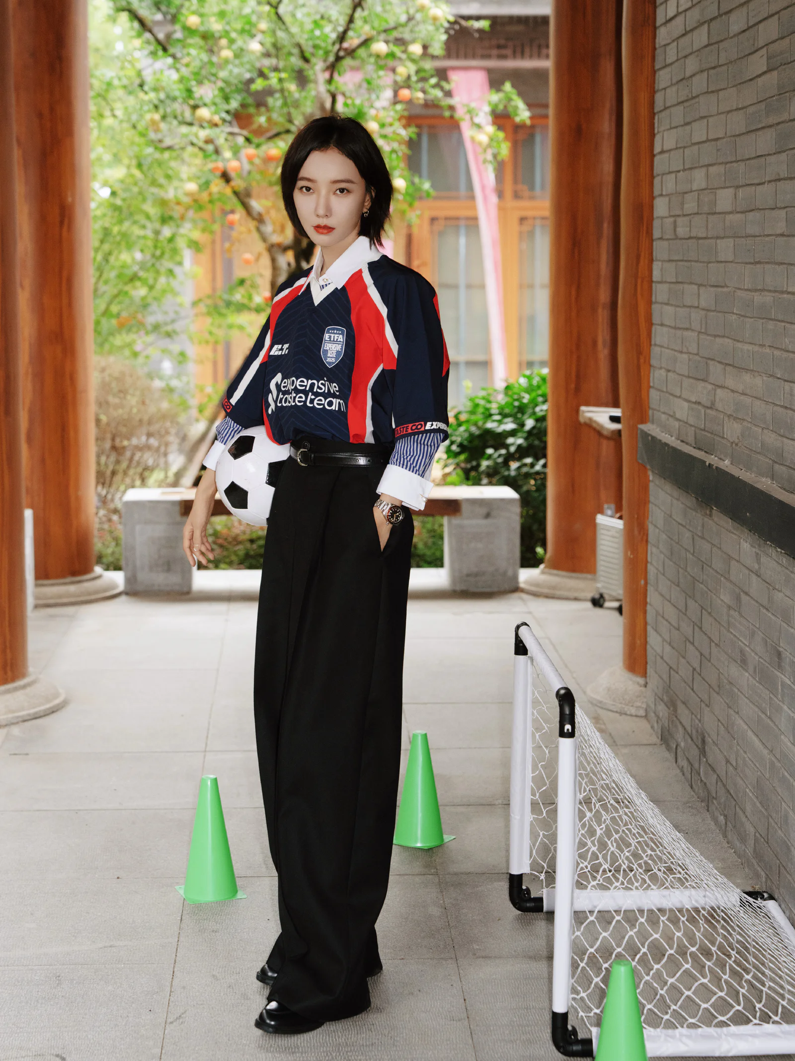 Sporty Chic: Football Jersey and Black High-Waisted Trousers for a Bold Statement