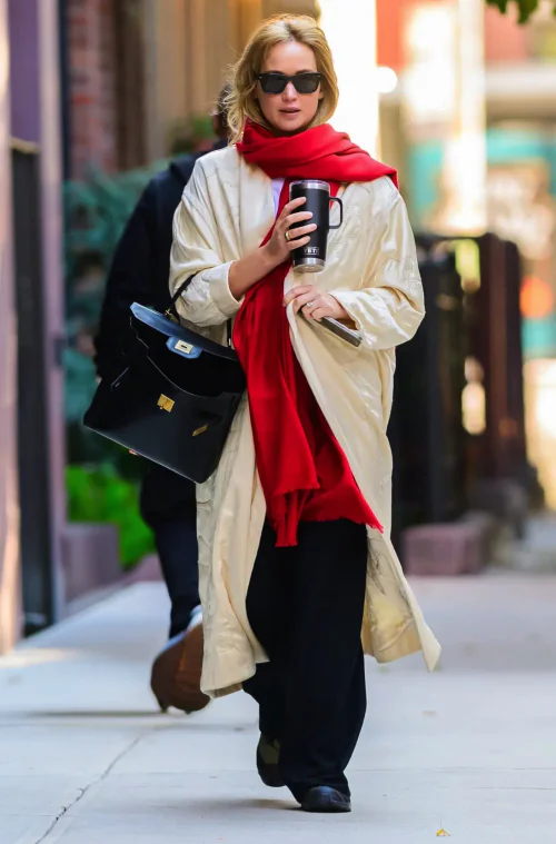 Casual Chic: Cream Coat with Red Scarf and Black Accessories