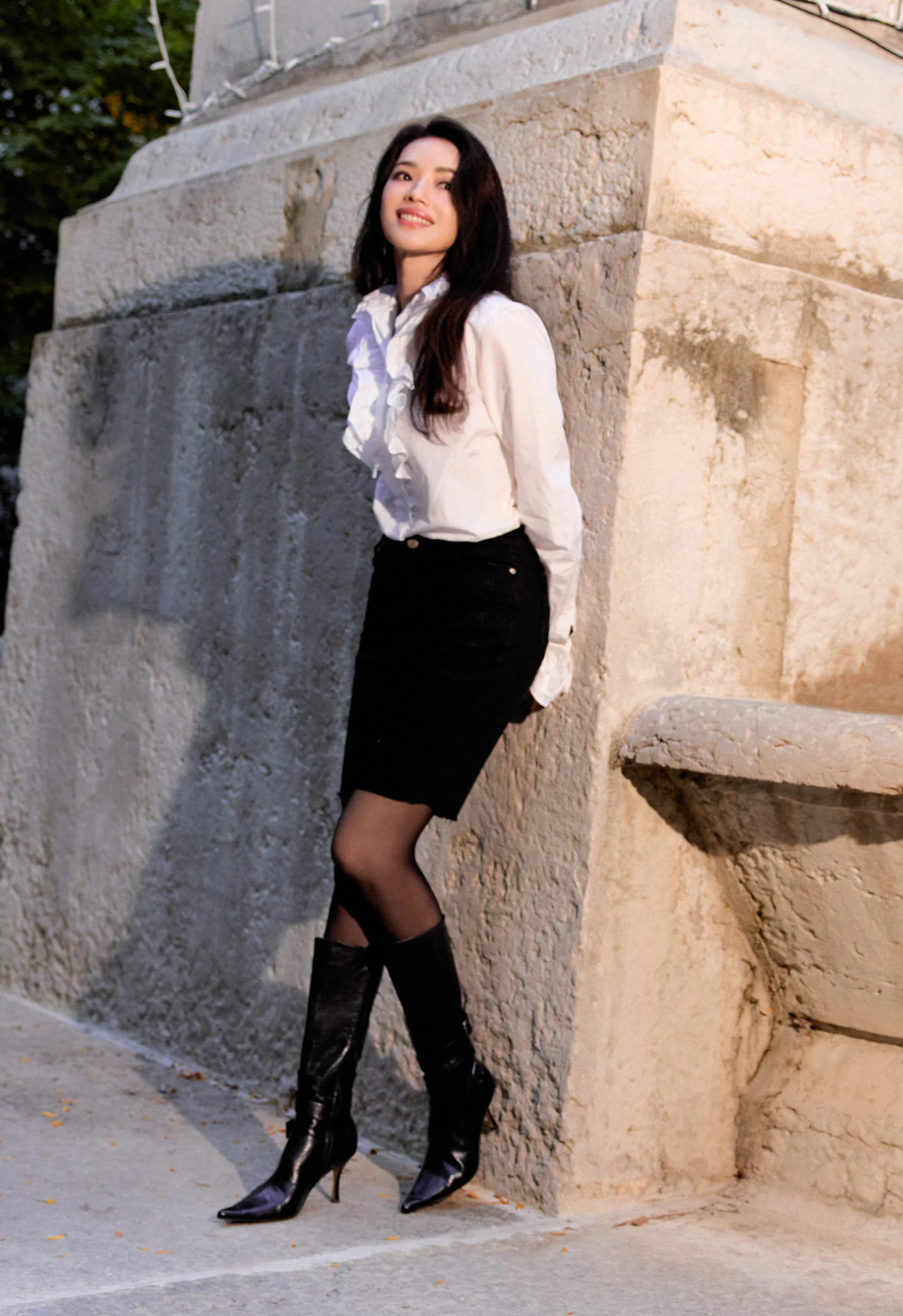 Elegant White Ruffled Blouse and Black Skirt with Sleek Leather Boots