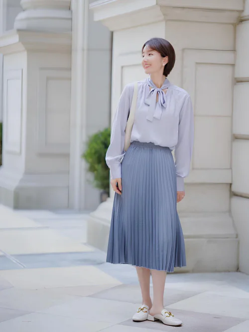Elegant Lavender Blouse with Pleated Blue Skirt and White Loafers