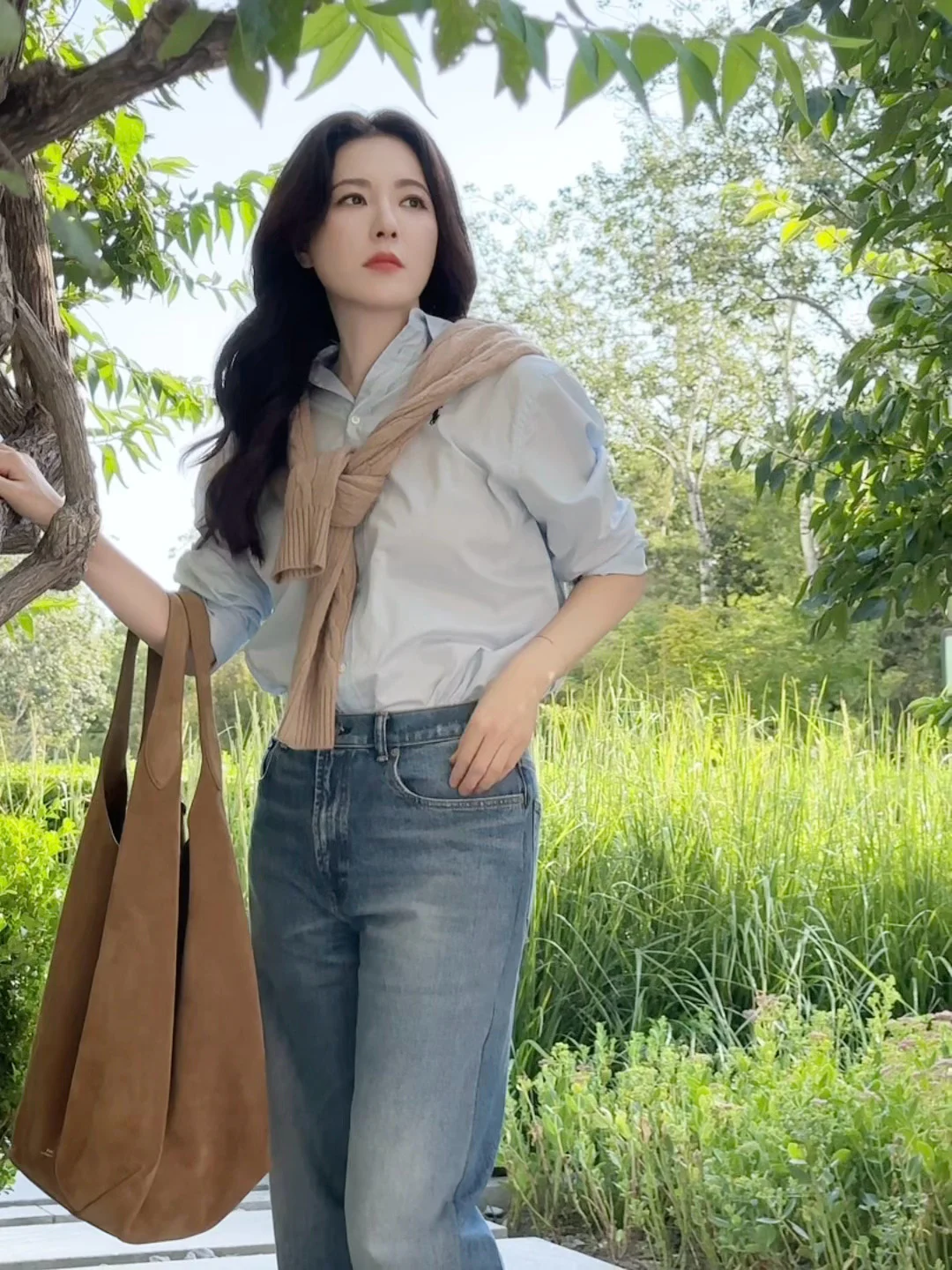 Casual Chic: Light Blue Shirt with Beige Sweater and Denim Jeans
